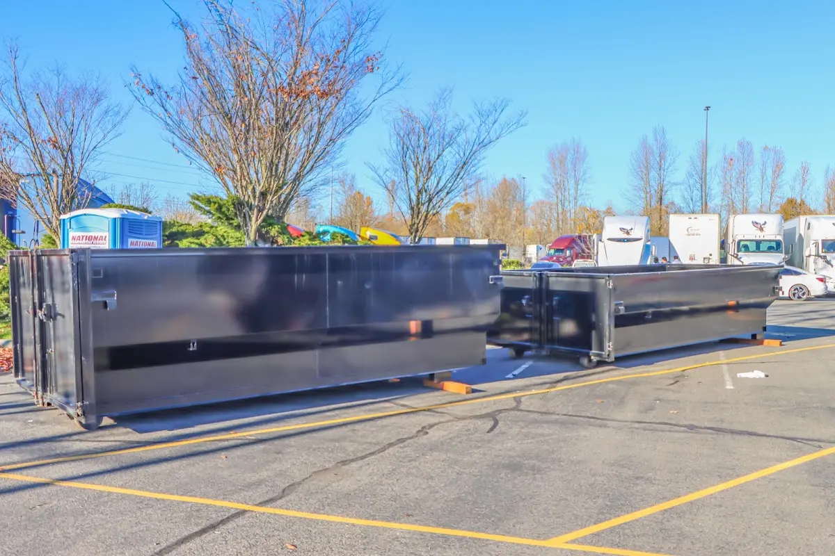 Professional dumpster rental service with roll-off container on residential driveway in Elk River